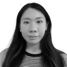 Black-and-white headshot of a person with long hair, striped top, neutral expression