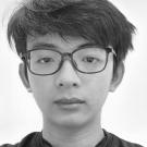Black-and-white portrait of a young man wearing glasses, neutral expression